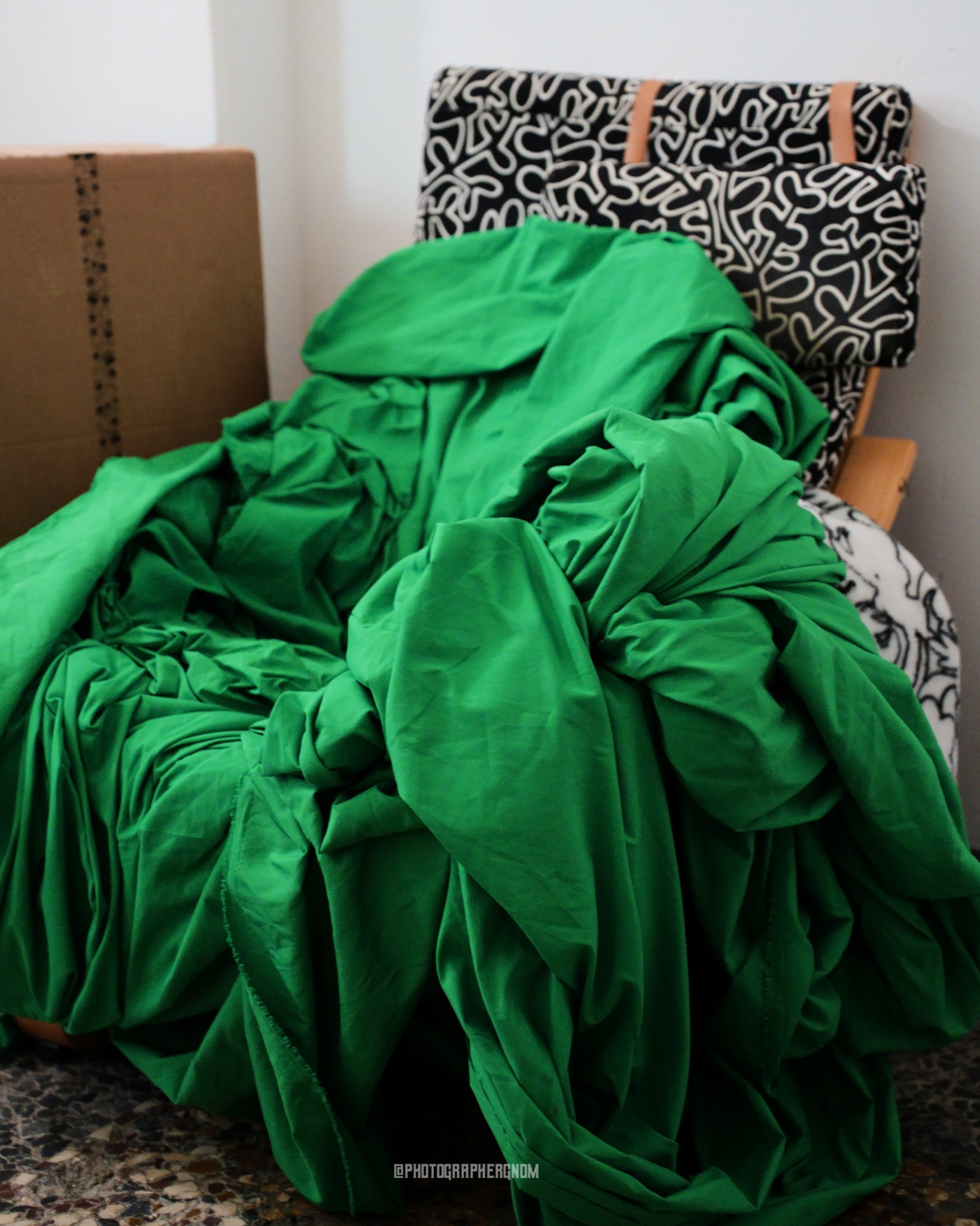 Green fabric gathered with orange stitching