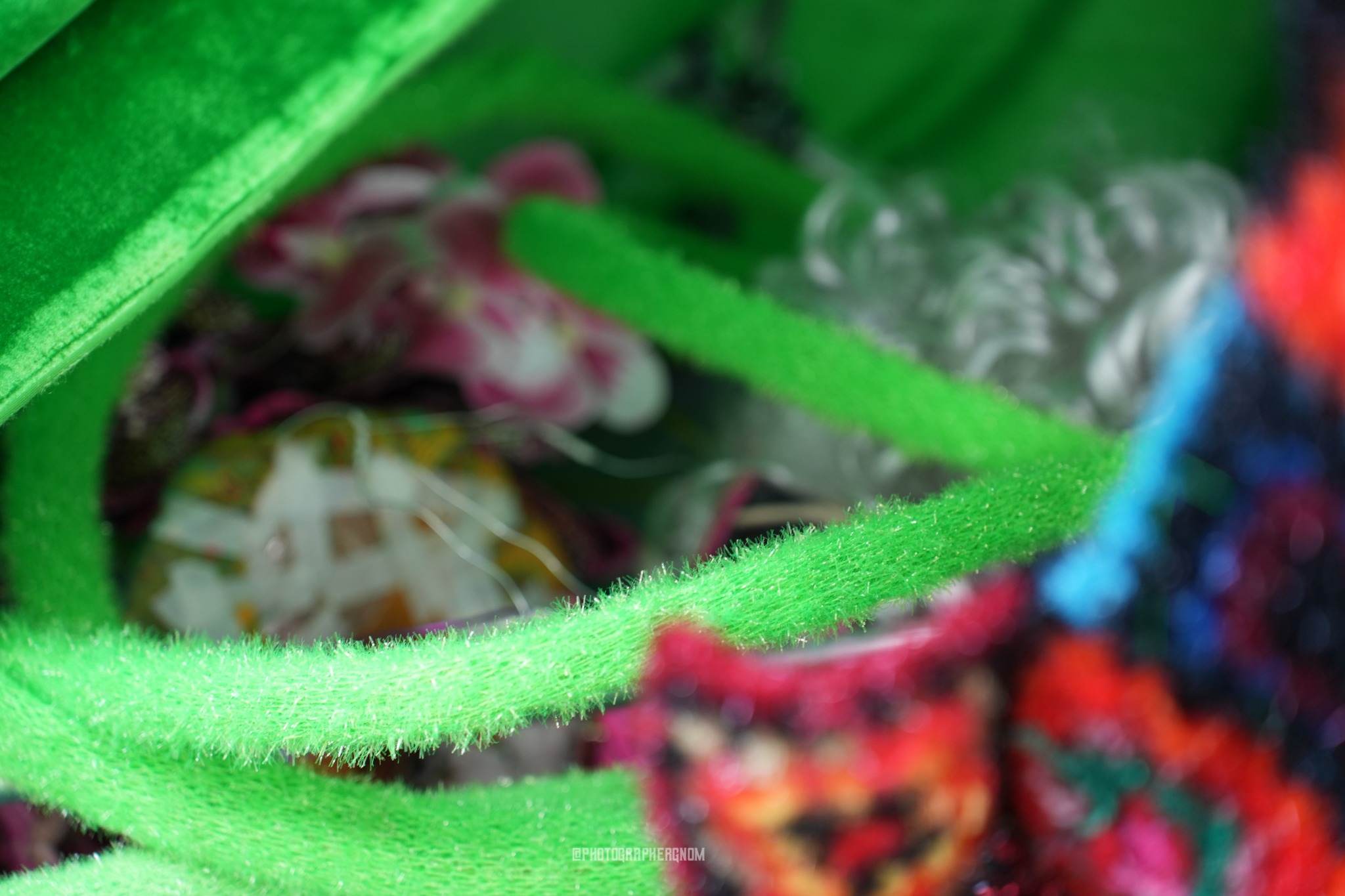 Green textile loop beside multicoloured crochet