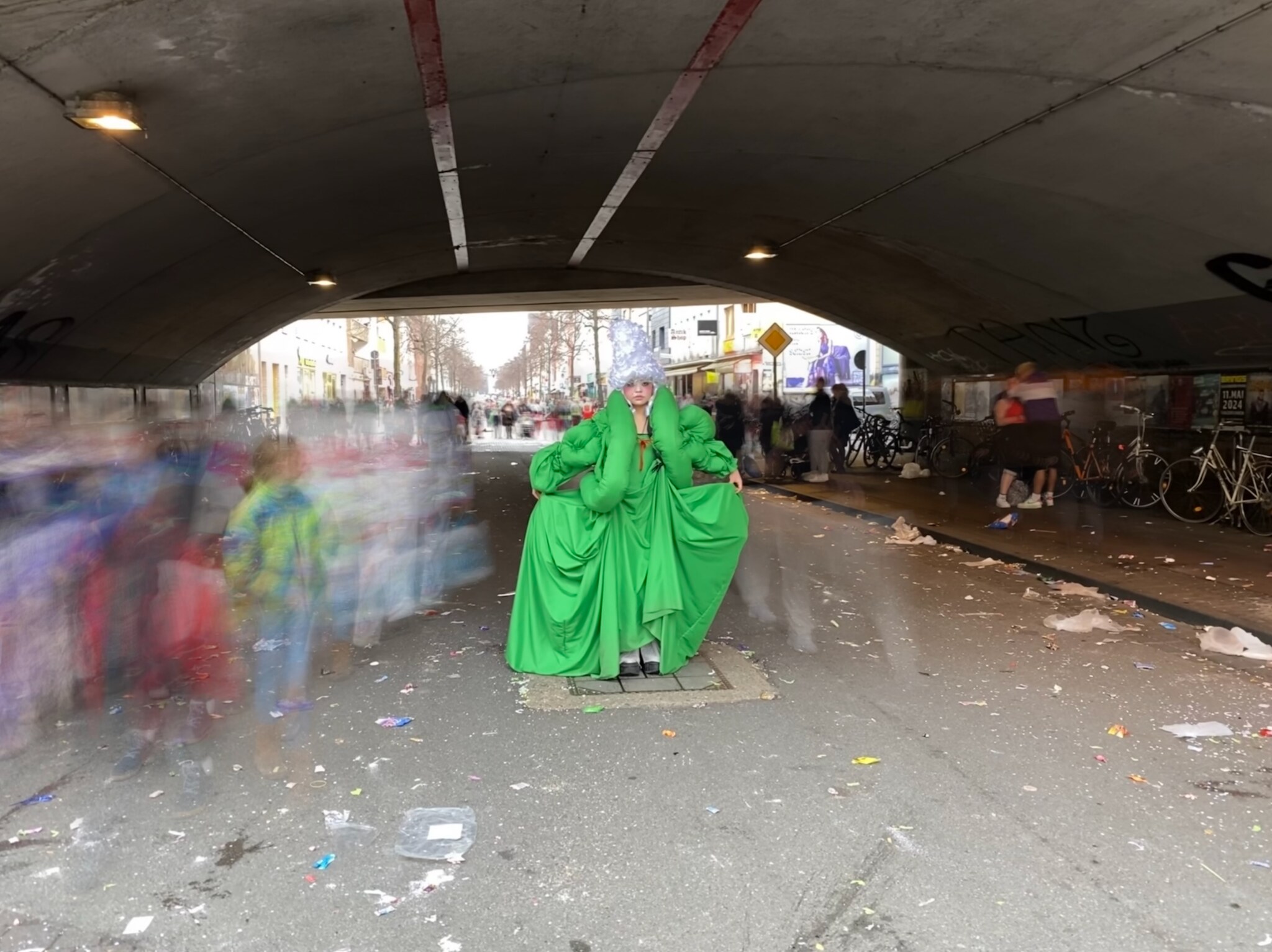 Noblewoman beneath a bridge as people pass
