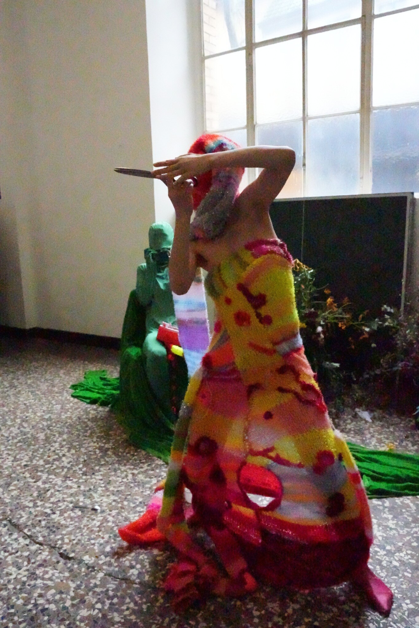 Coral figure raising a soft multicoloured form