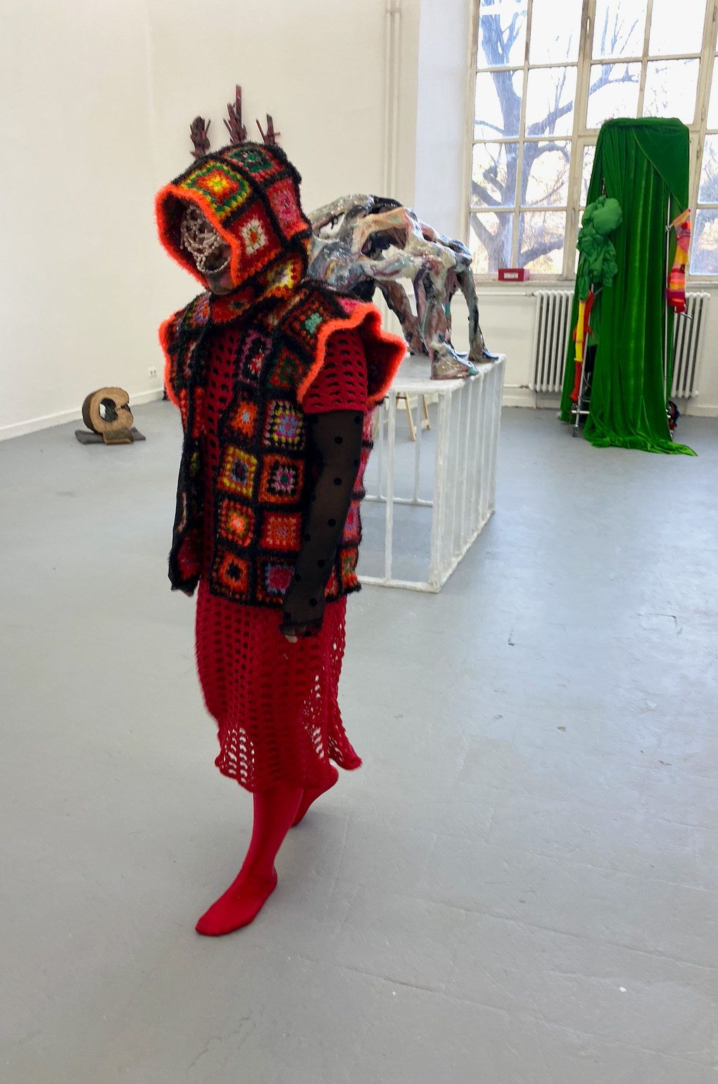 Red beetle figure standing in the exhibition space