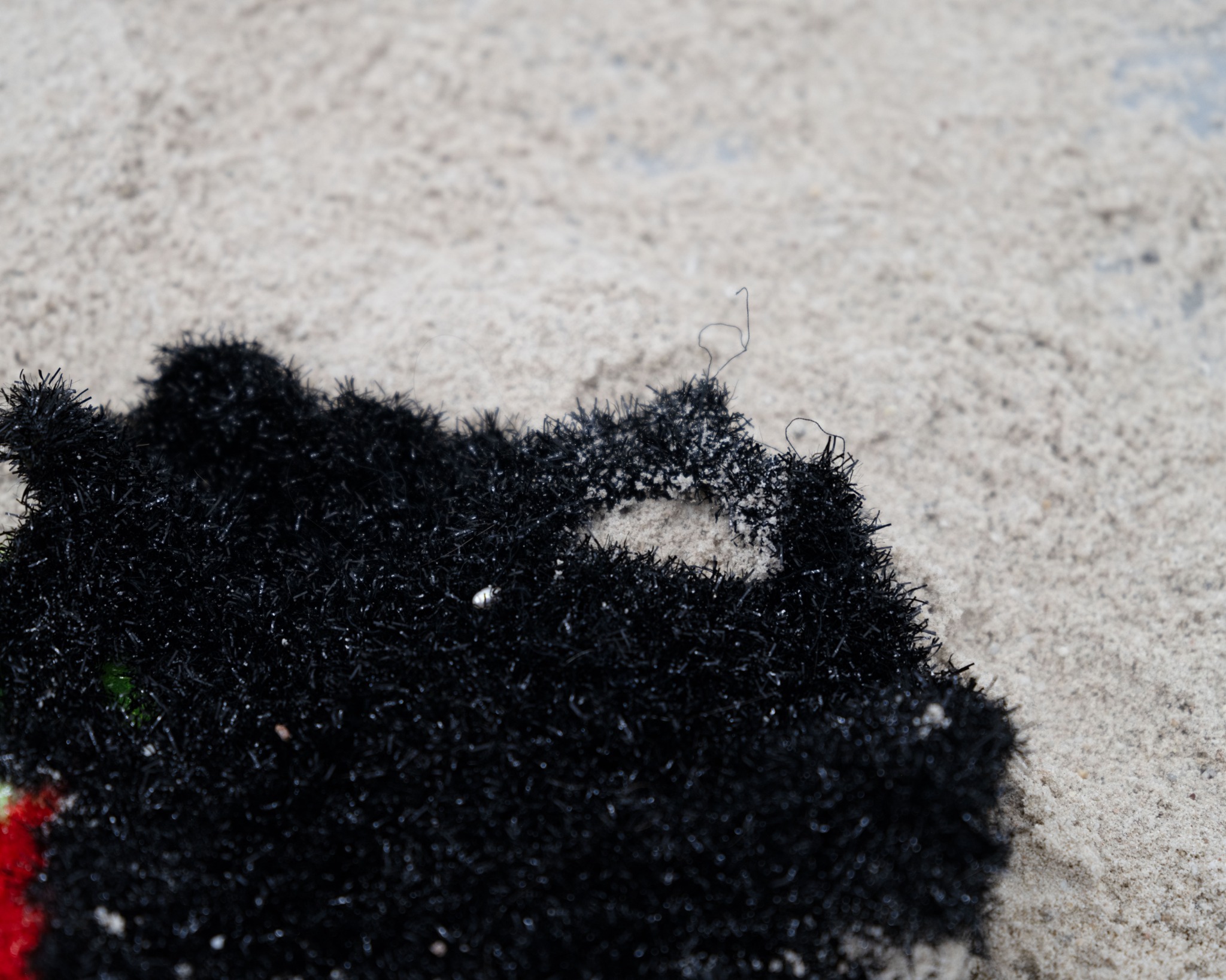Black polyester yarn and sand detail