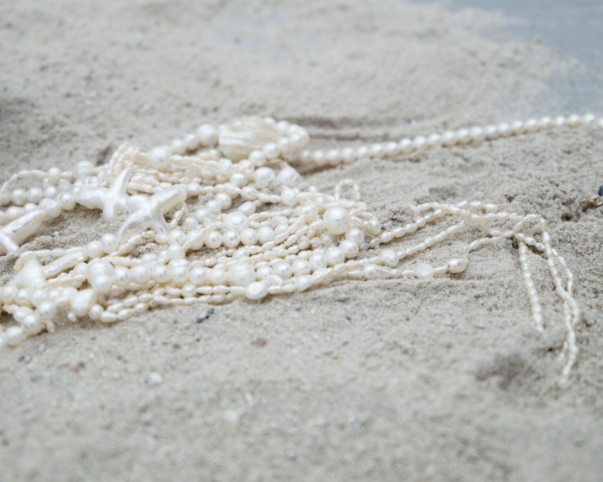 Pearls arranged across sand