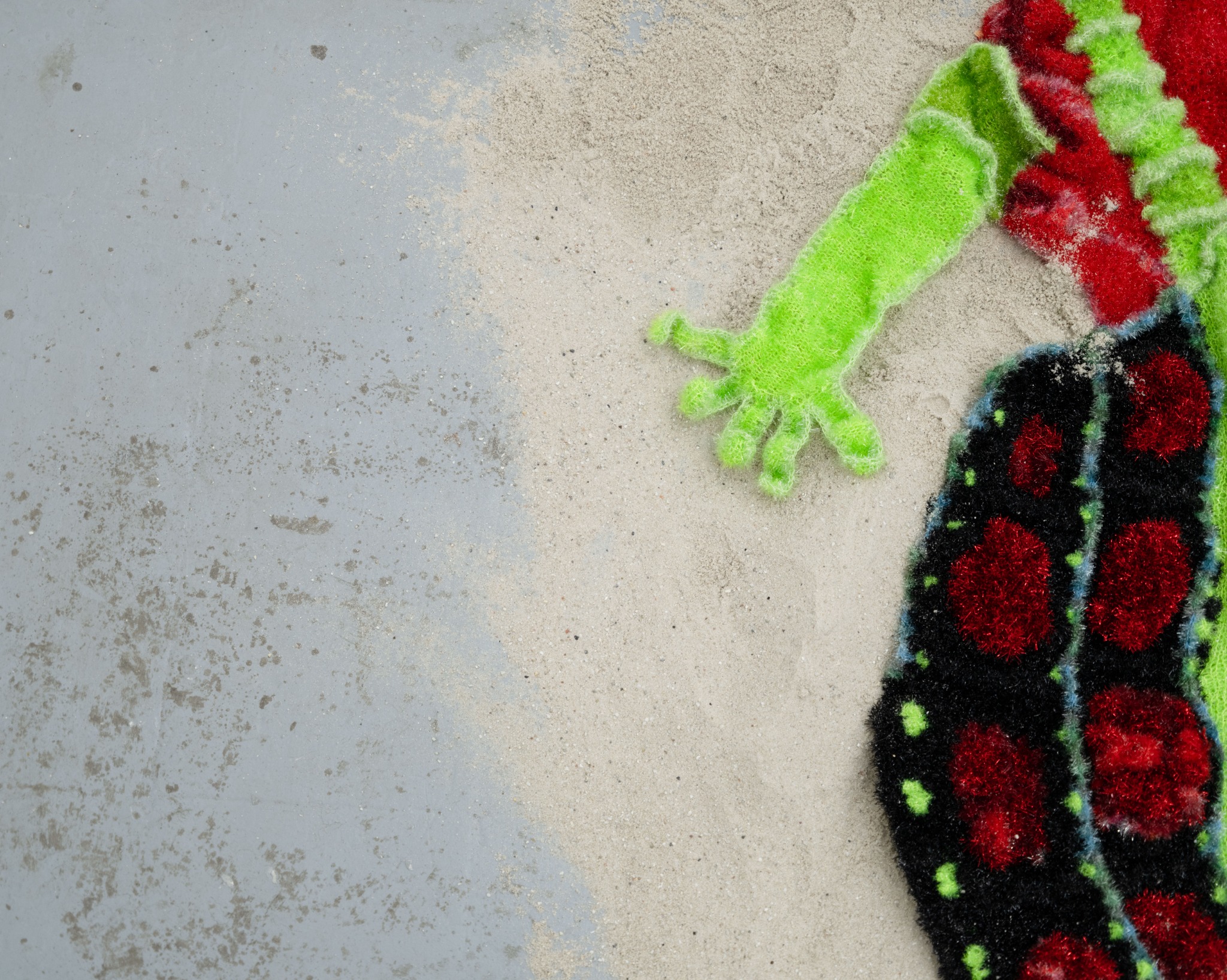 Green textile limb and black patterned body detail