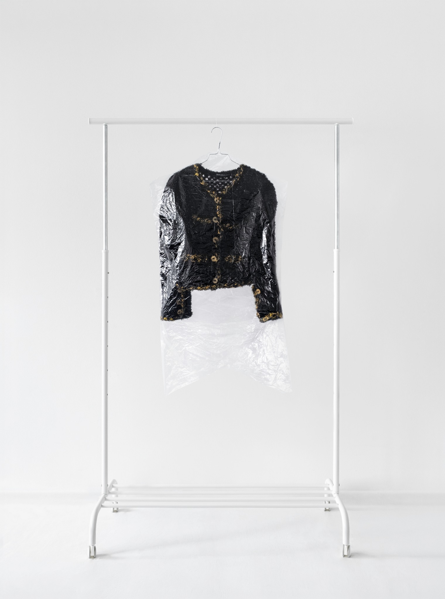 POUR TROIS SOUS – No. 2 displayed on a clothes rack