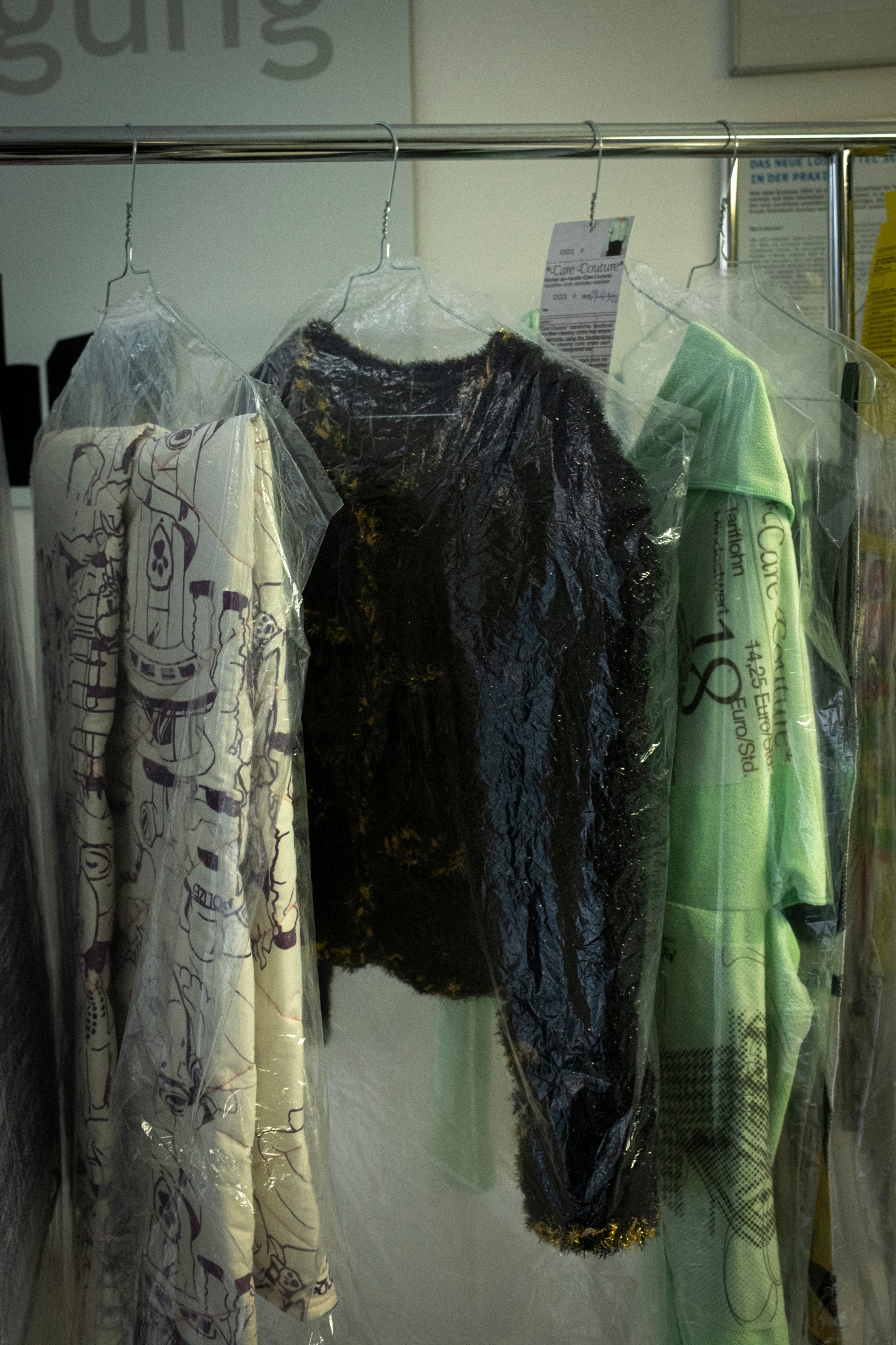 The work installed among garments at City Reinigung